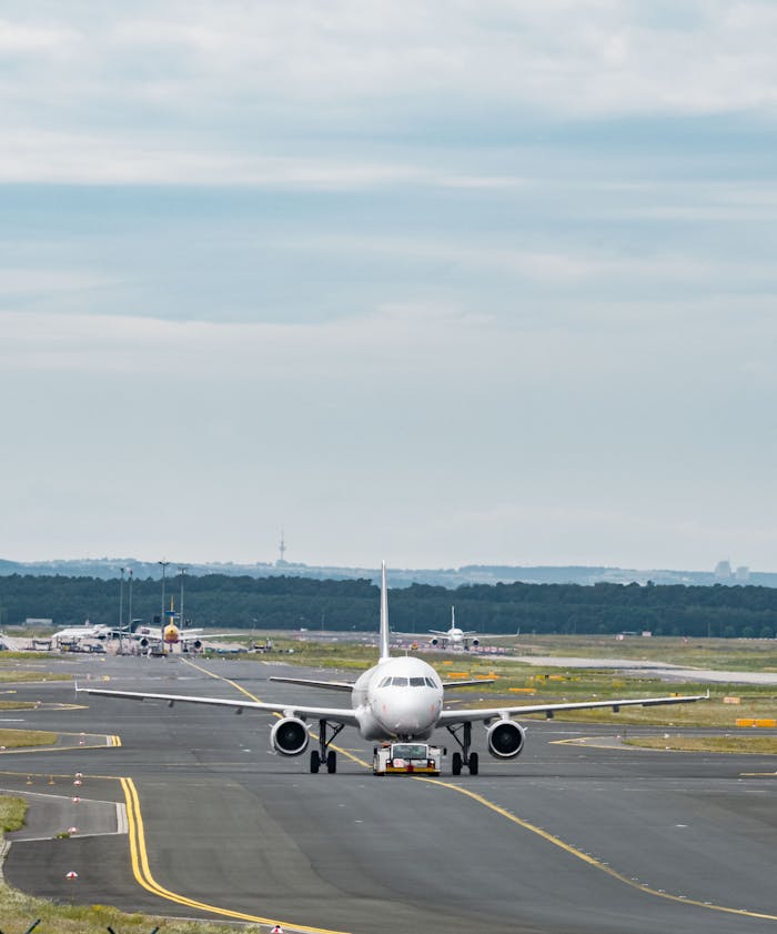 A commercial aircraft taxiing on the runway at Frankfurt Airport, ready for takeoff.